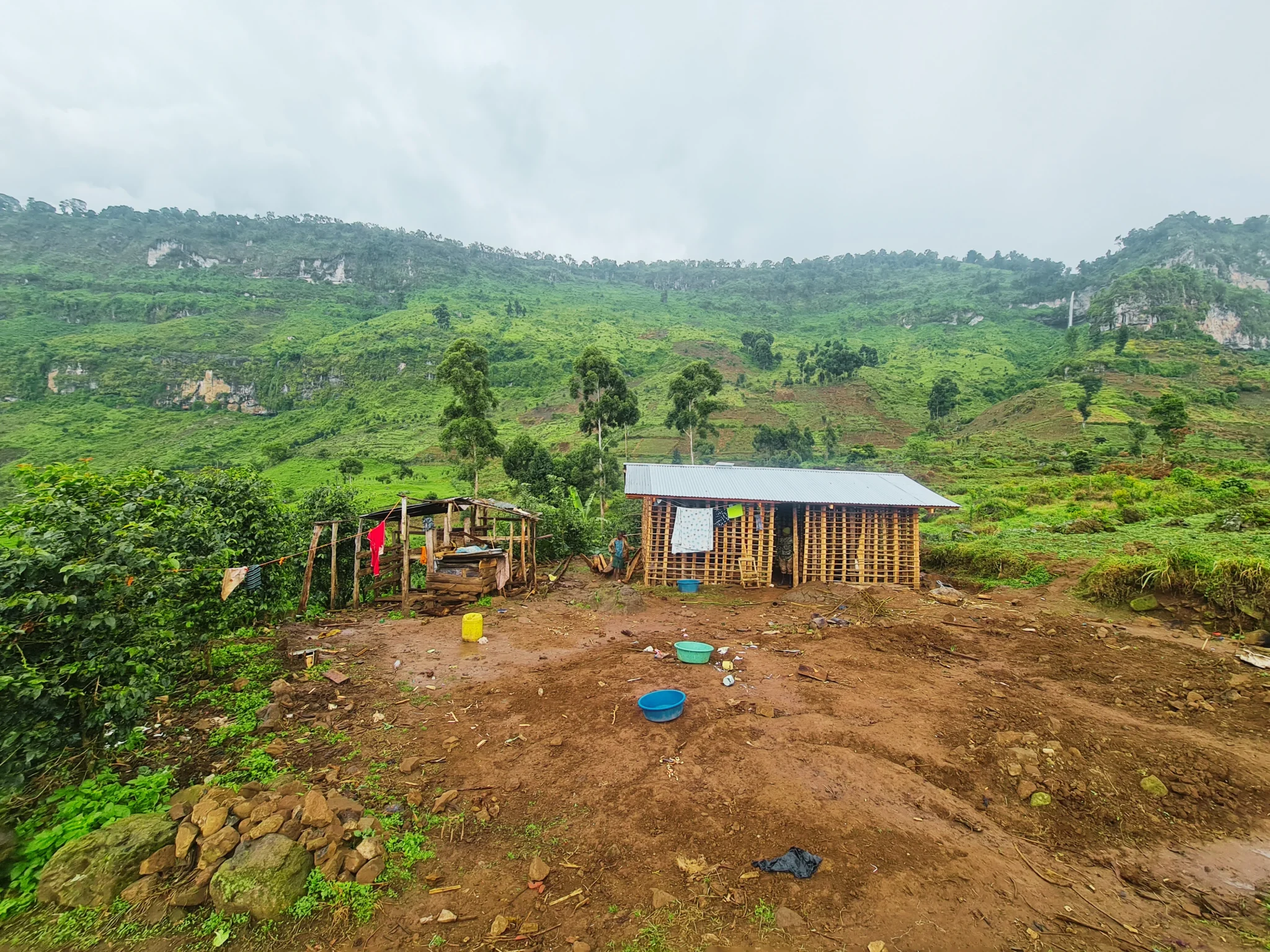 Community home with Nabunyifu Falls in background